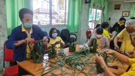 คุณอัมพร แสงราช ผู้สูงอายุชุมชนสองแคว1 ปราชญ์เรื่อง สานใบมะพร้าว และจัดทำตุง